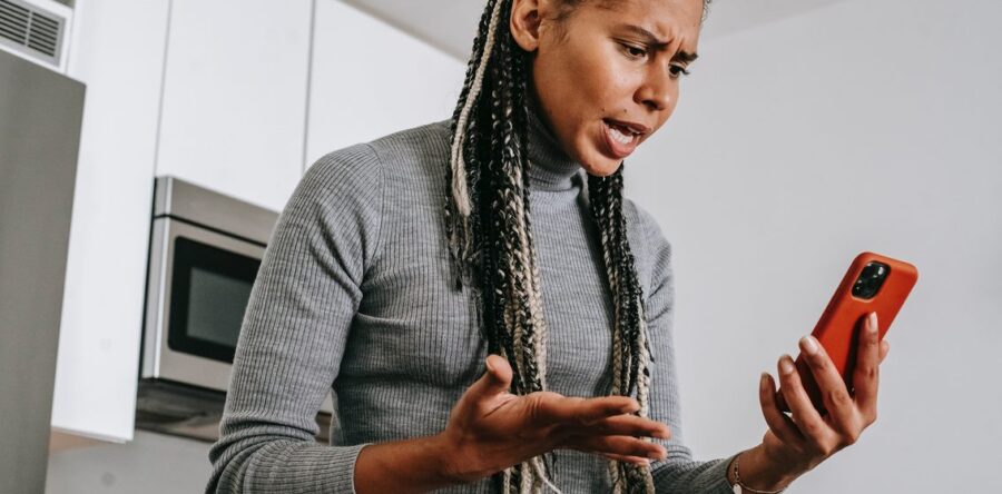 Woman mad while looking at her phone