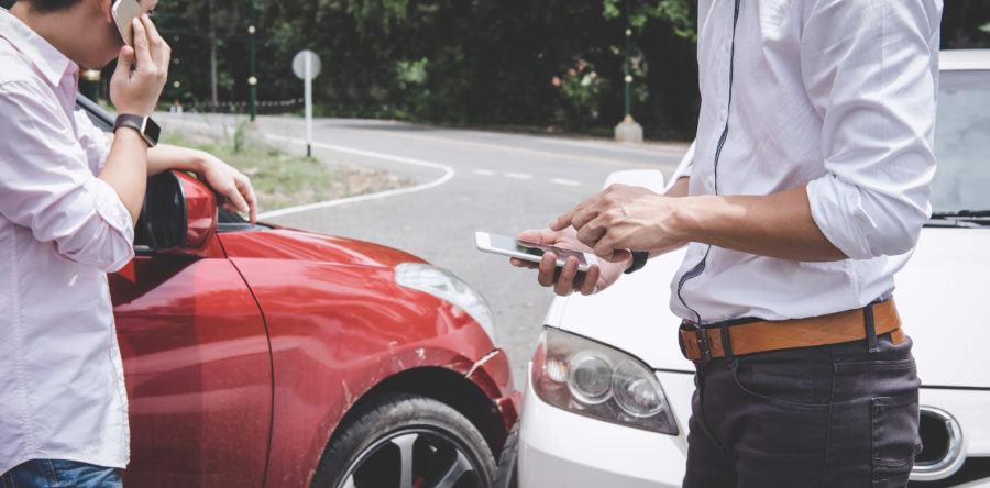 People exchanging information after being in a car accident