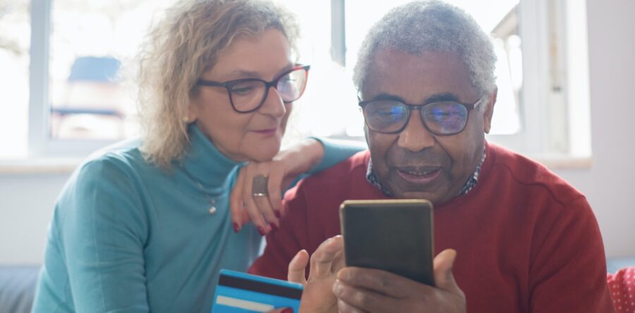 Two older people looking at a smart phone