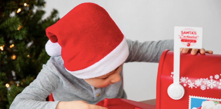 Kid looking in Santa's mailbox