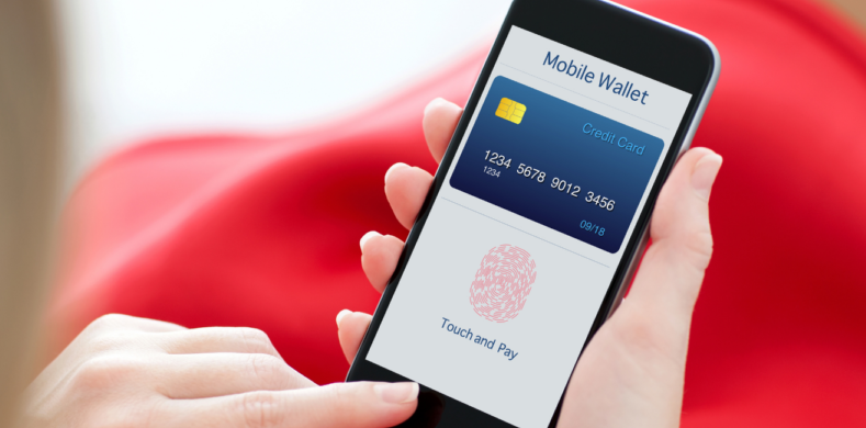 Shows a person using a mobile wallet to access a debit or credit card using their finger print