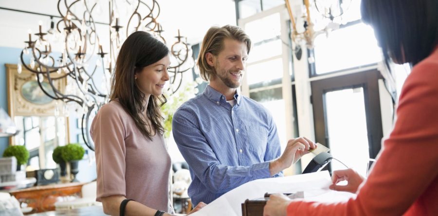 Couple paying for something on a credit card machine