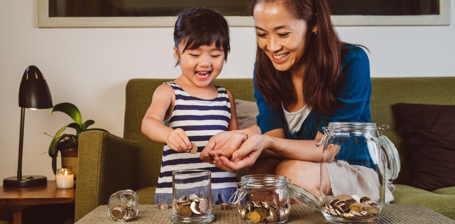Kid counting coins with mother