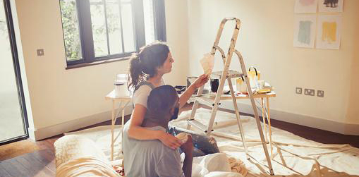 Couple looking at paint samples in unpainted room