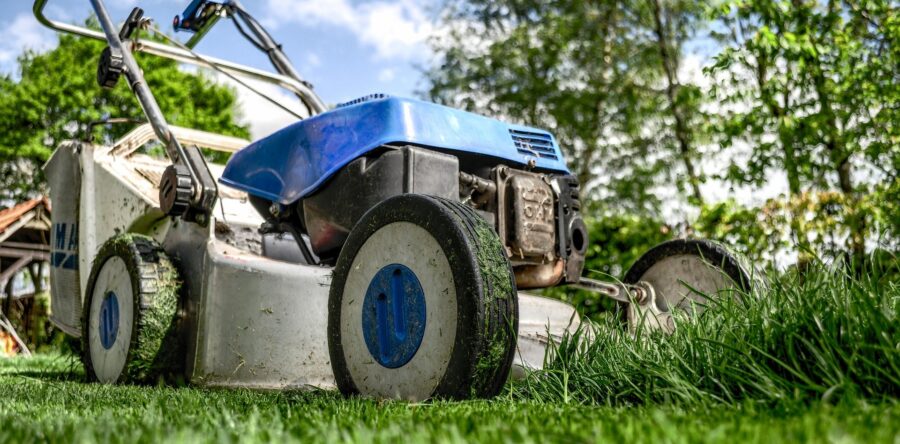 Lawnmower part of the way through cutting a lawn