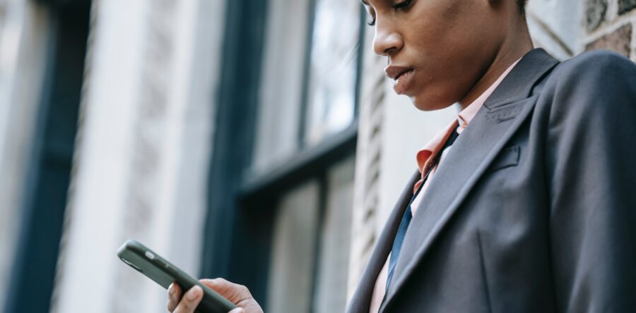 Man in suit looking at phone