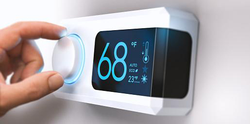 Person changing the thermostat to 68 degrees Fahrenheit